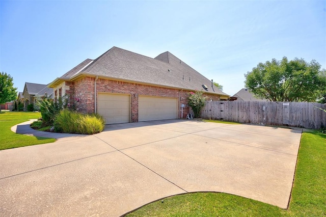 view of home's exterior with a garage and a yard