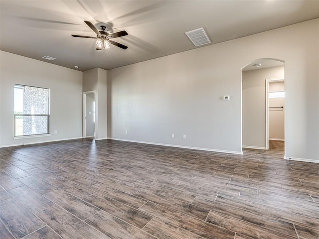 empty room featuring ceiling fan and dark hardwood / wood-style flooring