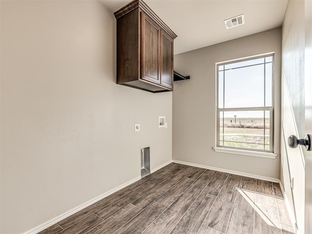 washroom with cabinets, washer hookup, dark hardwood / wood-style flooring, and electric dryer hookup