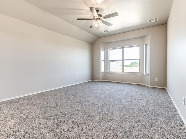 unfurnished room featuring lofted ceiling, carpet floors, and ceiling fan