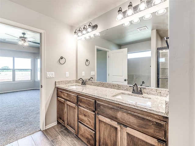 bathroom featuring ceiling fan and vanity