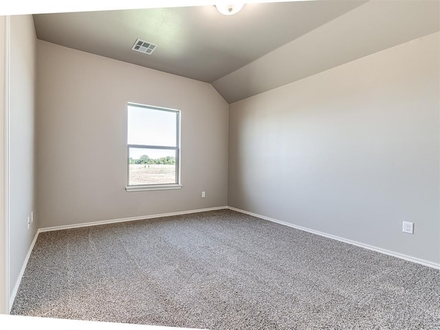 unfurnished room featuring carpet flooring and vaulted ceiling