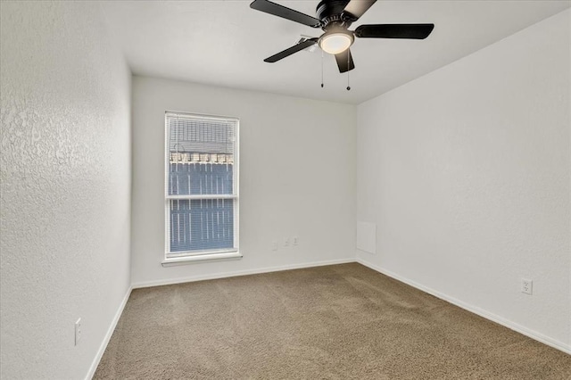 spare room featuring ceiling fan and carpet flooring