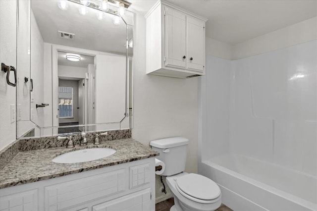 full bathroom with vanity, bathtub / shower combination, and toilet