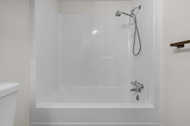 bathroom with toilet and shower / bath combination