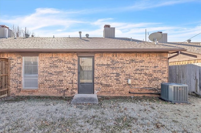 back of house with central AC unit