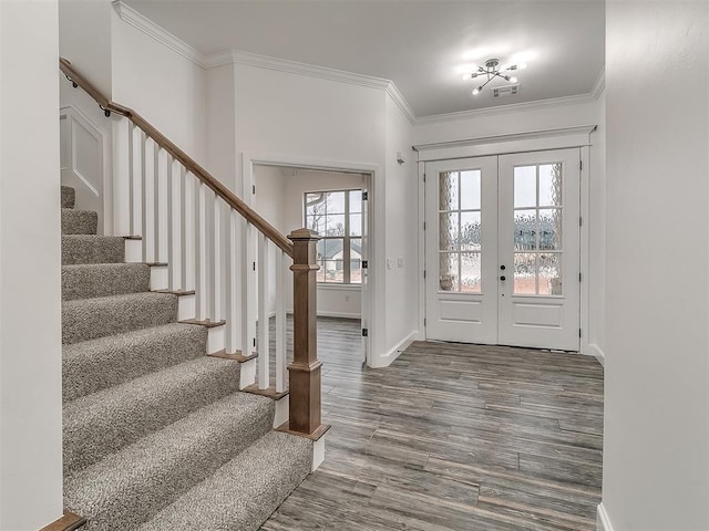 foyer featuring french doors, wood-type flooring, and crown molding