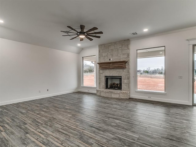 unfurnished living room featuring ceiling fan, vaulted ceiling, dark hardwood / wood-style floors, and a fireplace