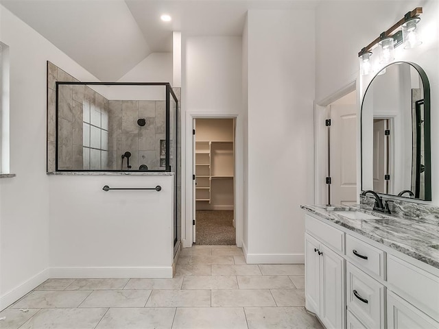 bathroom featuring vanity, tile patterned floors, vaulted ceiling, and a shower with door