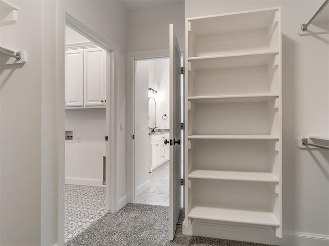 spacious closet featuring light tile patterned floors