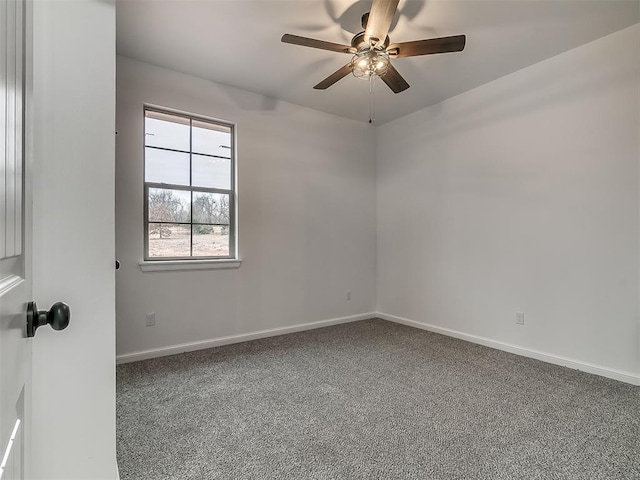 empty room featuring ceiling fan and carpet