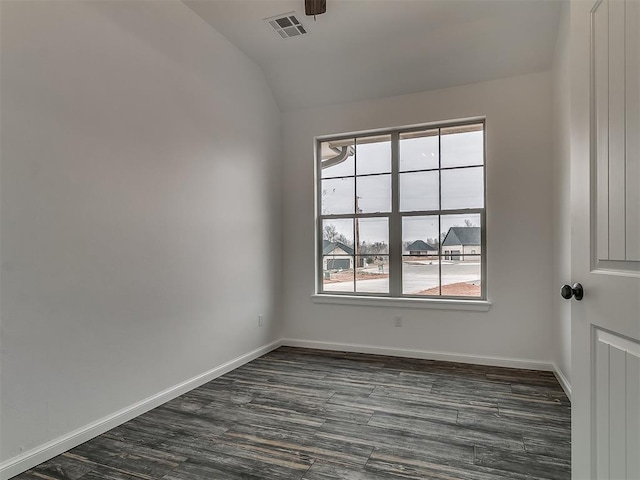 empty room featuring lofted ceiling and dark hardwood / wood-style floors