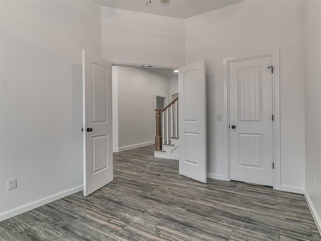 unfurnished room featuring dark wood-type flooring