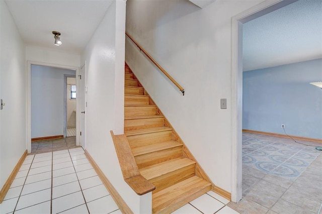 stairs featuring tile patterned flooring