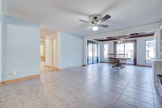 unfurnished room with light tile patterned floors, a textured ceiling, and ceiling fan