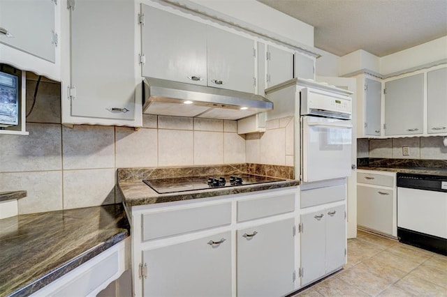 kitchen with tasteful backsplash, white appliances, and white cabinets