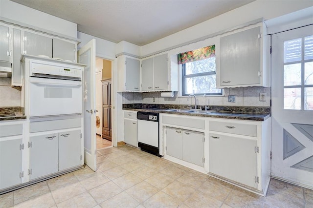 kitchen with sink, white cabinets, white appliances, and decorative backsplash