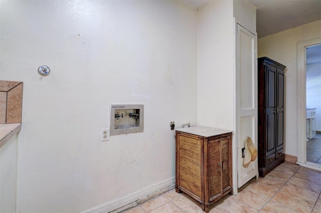 laundry area with light tile patterned floors, hookup for a washing machine, and hookup for an electric dryer