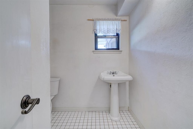 bathroom featuring tile patterned flooring and toilet