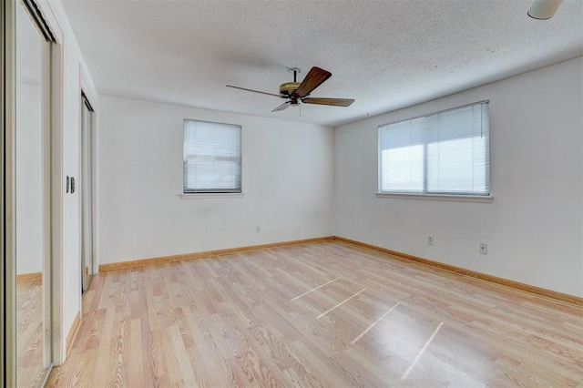 unfurnished bedroom with ceiling fan, light hardwood / wood-style flooring, a closet, and a textured ceiling