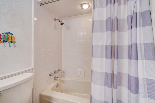 bathroom with shower / tub combo with curtain and toilet