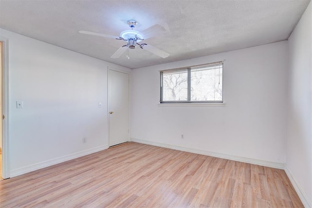 empty room featuring ceiling fan, a textured ceiling, and light hardwood / wood-style floors