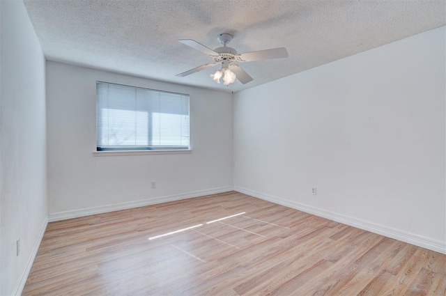 empty room featuring ceiling fan, a textured ceiling, and light wood-type flooring