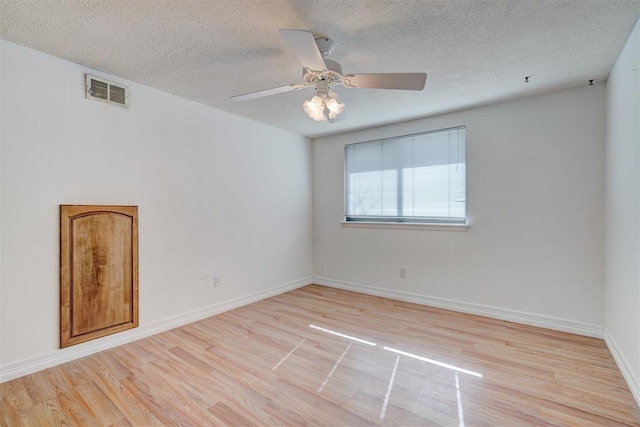 spare room featuring ceiling fan, a textured ceiling, and light hardwood / wood-style floors