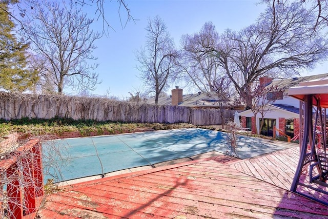 view of swimming pool featuring a wooden deck