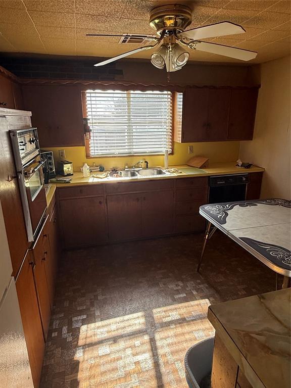 kitchen with wall oven, sink, dishwasher, and ceiling fan