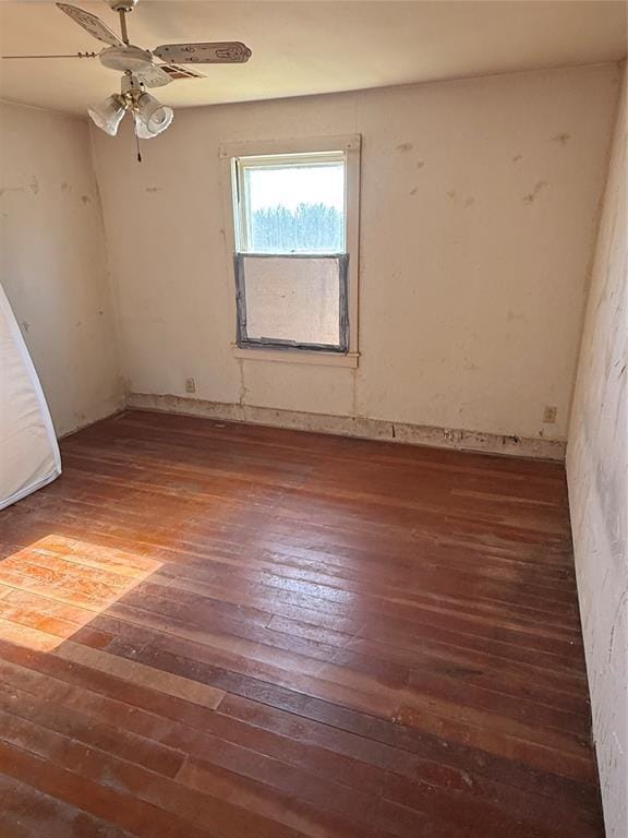 spare room featuring ceiling fan and dark hardwood / wood-style flooring