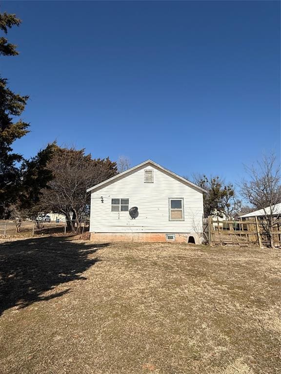 view of side of property with a lawn