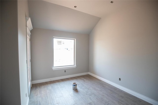 8116 NW 152nd Ter, Edmond, OK 73013 - empty room with wood finished floors and vaulted ceiling