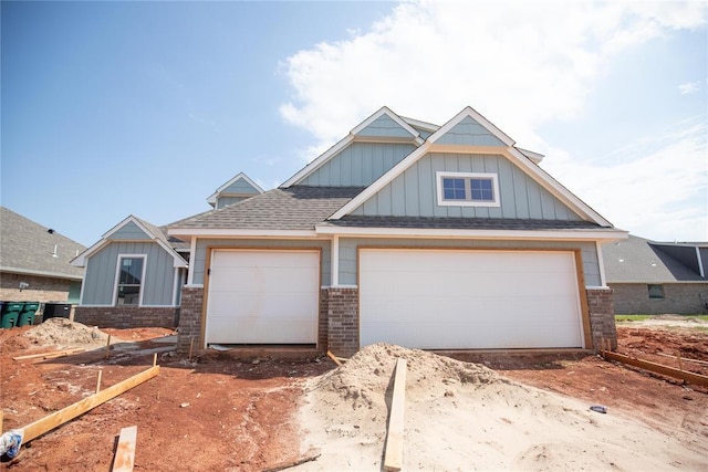 8116 NW 152nd Ter, Edmond, OK 73013 - view of front of home with brick siding, board and batten siding, roof with shingles, and driveway