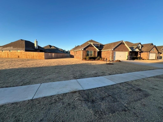 ranch-style home with a garage and a front lawn