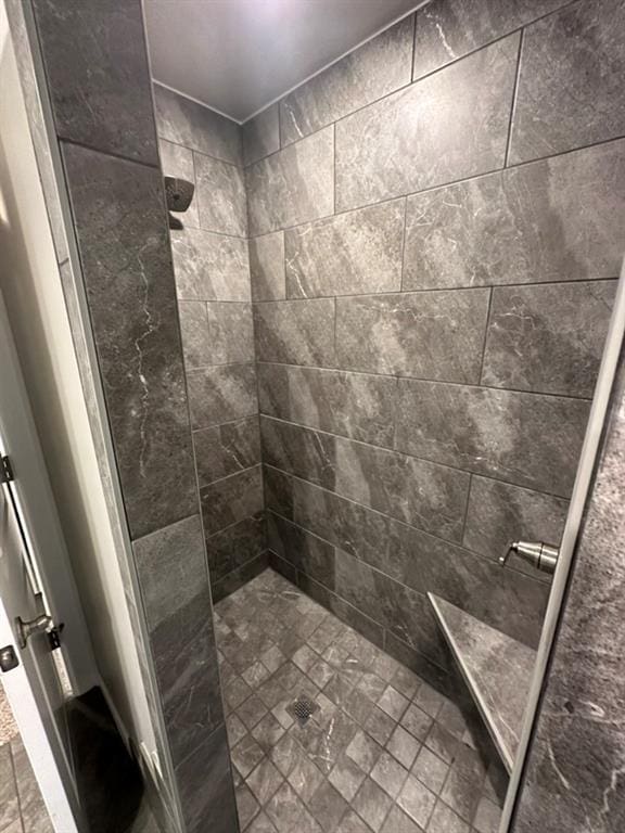 bathroom with tiled shower