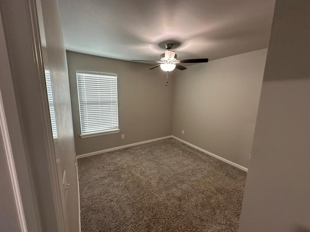 spare room featuring ceiling fan and carpet flooring