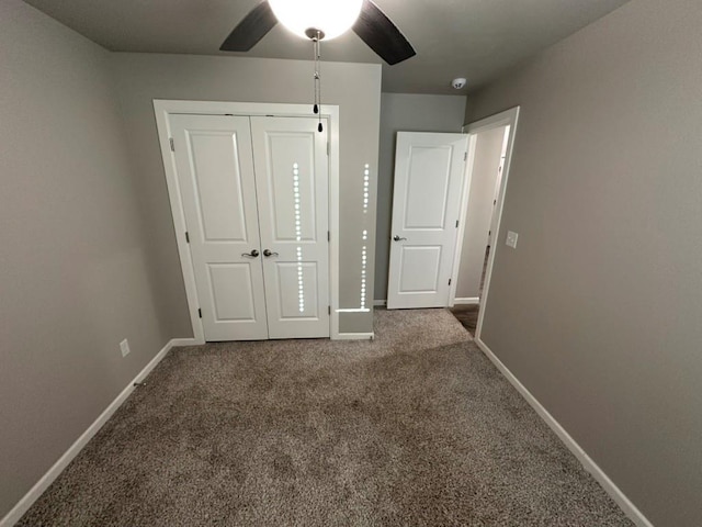 unfurnished bedroom featuring ceiling fan, a closet, and carpet