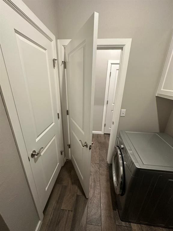 washroom with dark hardwood / wood-style flooring, washer / dryer, and cabinets