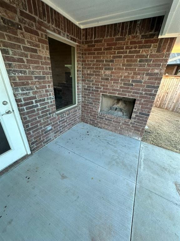 view of patio with a brick fireplace