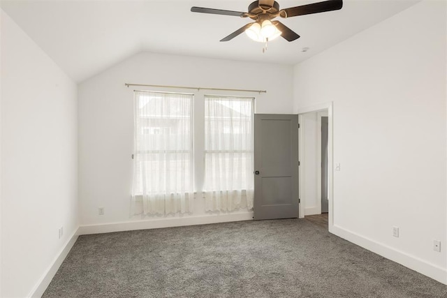 carpeted spare room with lofted ceiling and ceiling fan