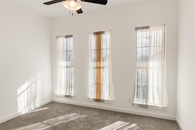 unfurnished room featuring ceiling fan, a healthy amount of sunlight, and carpet flooring