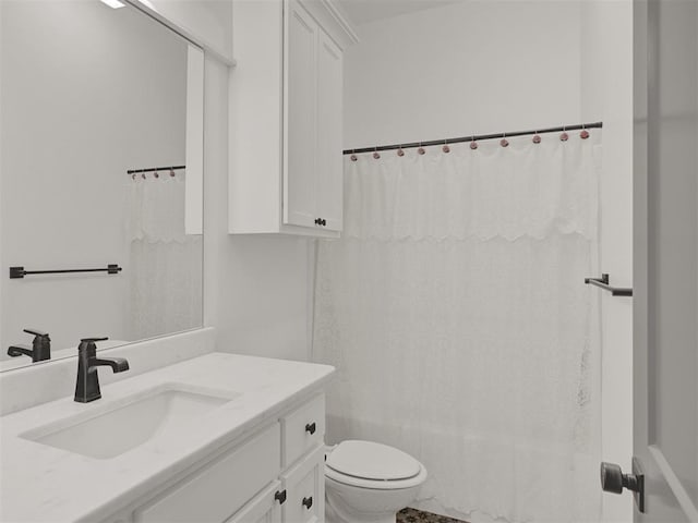 bathroom featuring vanity, curtained shower, and toilet