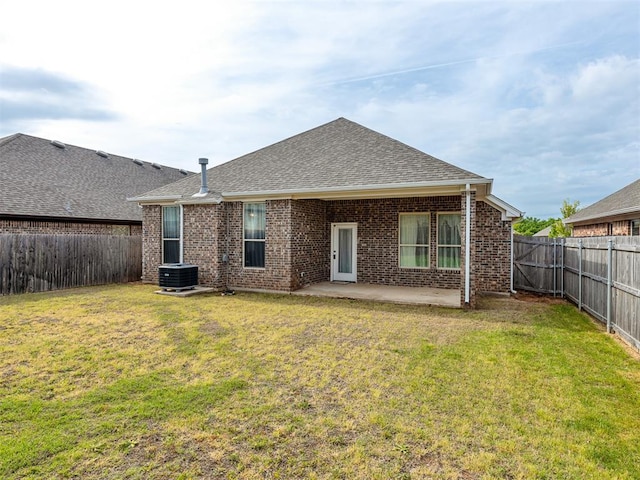 back of house featuring central AC, a yard, and a patio