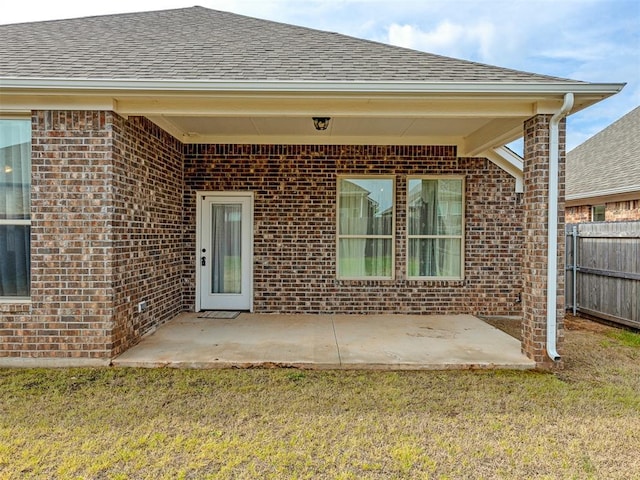 property entrance with a yard and a patio area