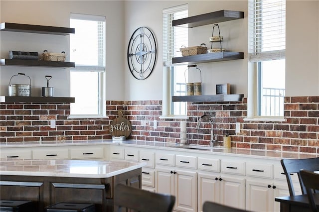 kitchen featuring white cabinetry, plenty of natural light, and sink