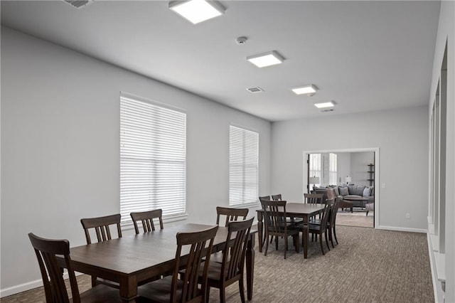 dining room with dark colored carpet