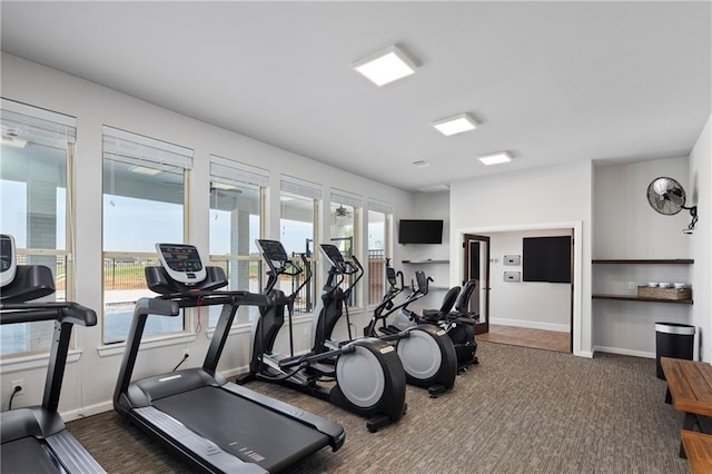 exercise room with dark colored carpet