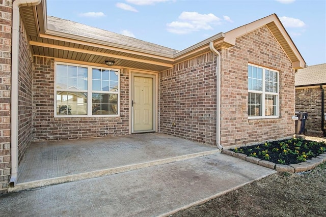 view of exterior entry featuring a patio