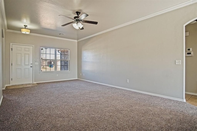 carpeted spare room featuring crown molding and ceiling fan